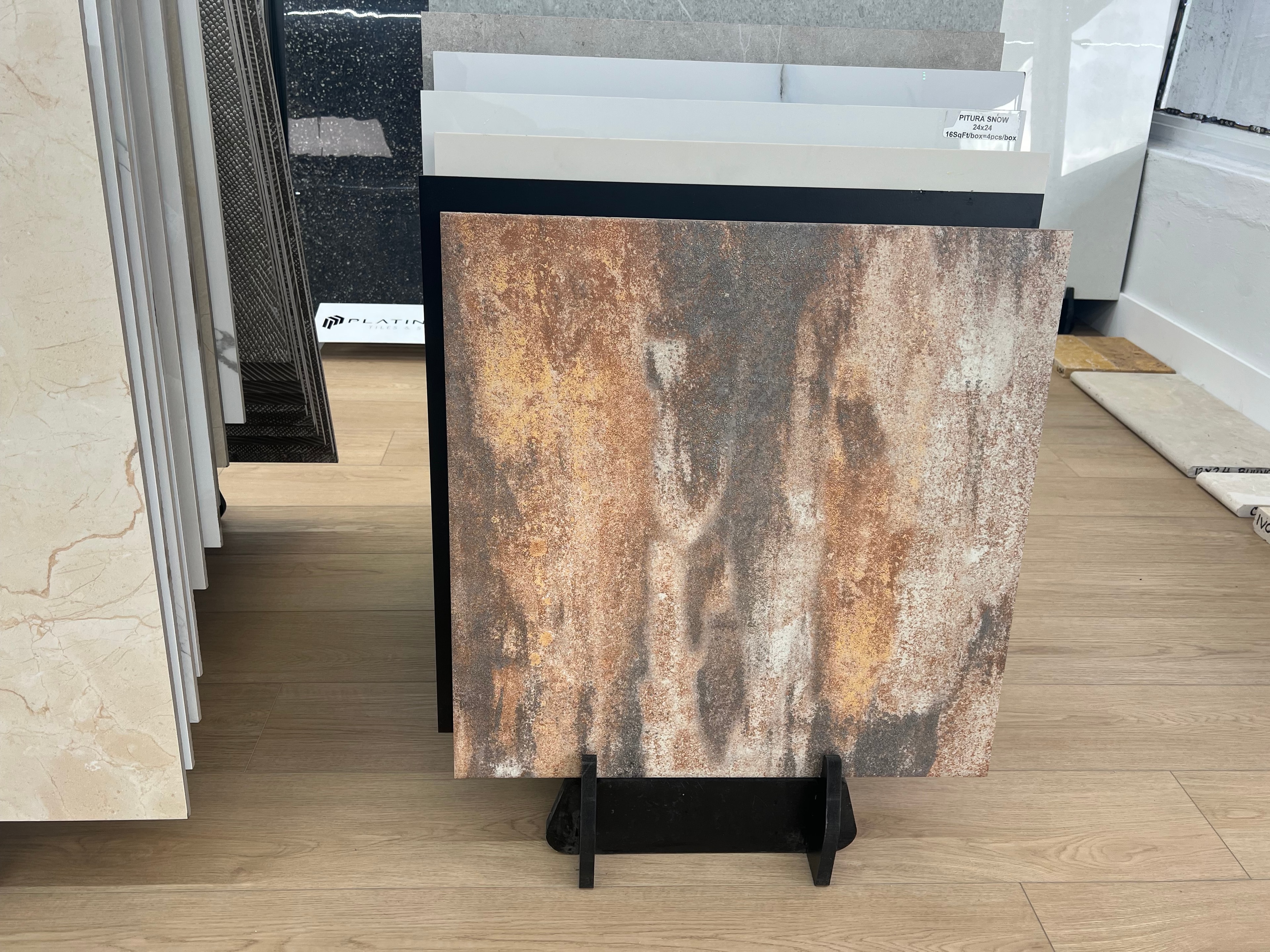 Porcelain tile sample with rustic weathered texture in warm browns and grays